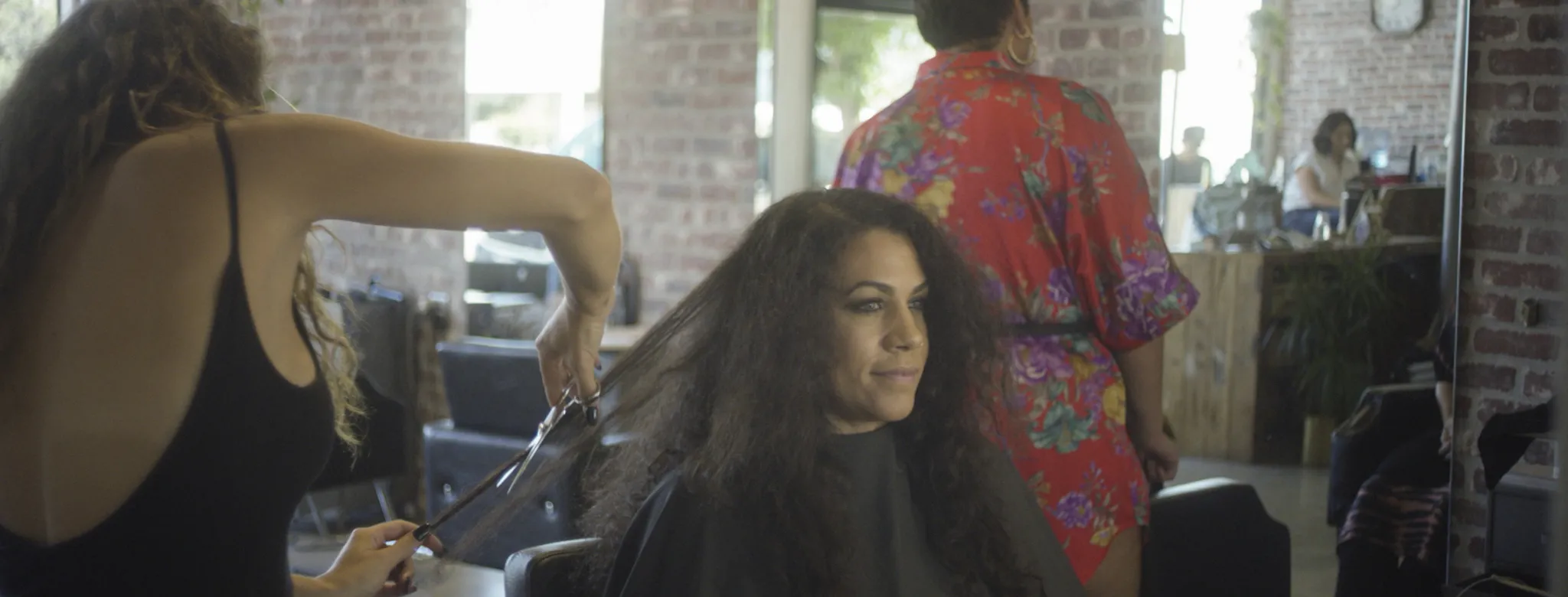 female stylist cutting hair in salon