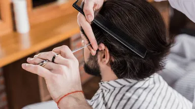 man getting haircut at barbershop