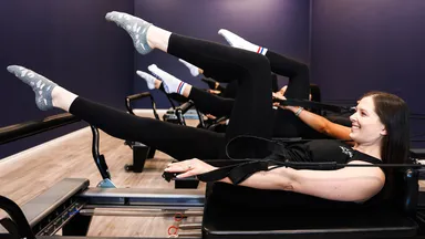 woman doing pilates on reformer