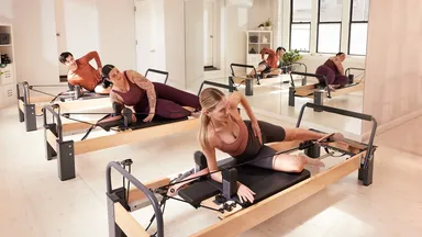 Three women taking a Pilates class.