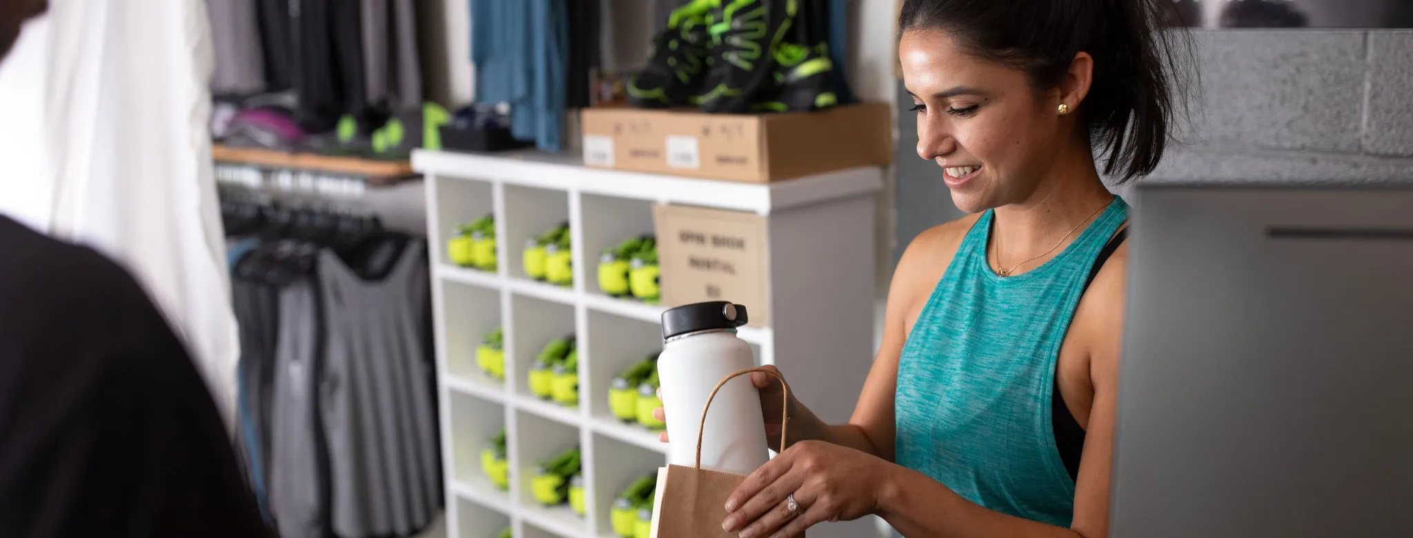 Employee selling retail at a fitness business