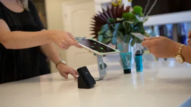 woman at desk with ipad and iphone