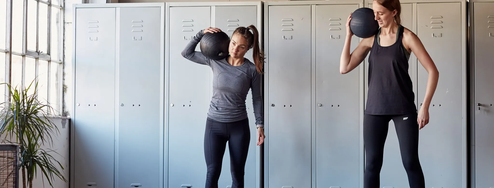 2 women holding med balls
