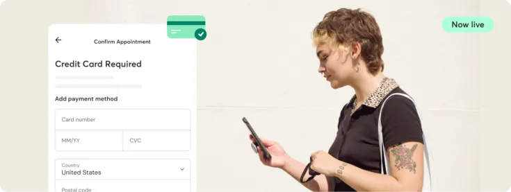 woman on phone paying to book her appointment