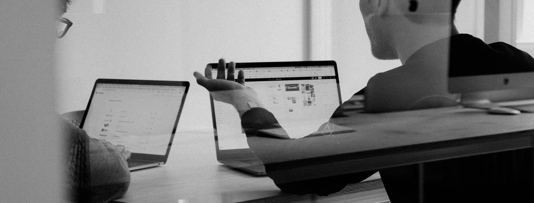 man and woman looking at computer