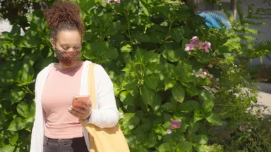 Woman in a mask on her phone