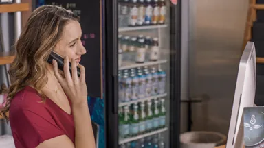 Person talking on phone at front desk