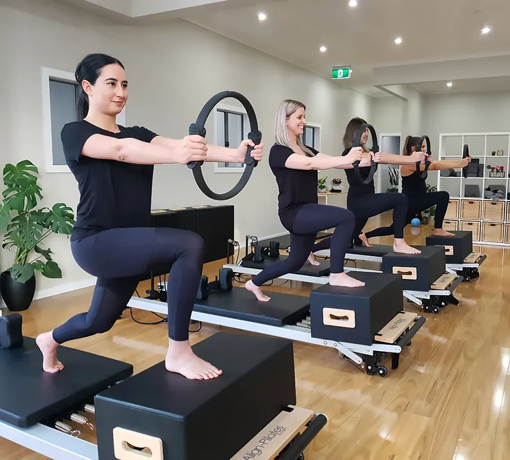 Women taking a Pilates class at Flex & Flow Pilates