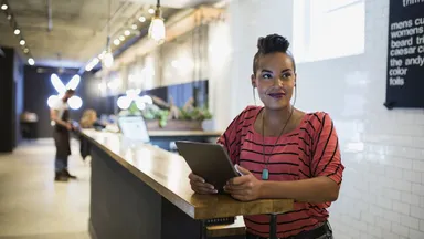 Woman at the front desk of a salon. 