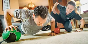 A GYMGUYZ coach teaching push ups