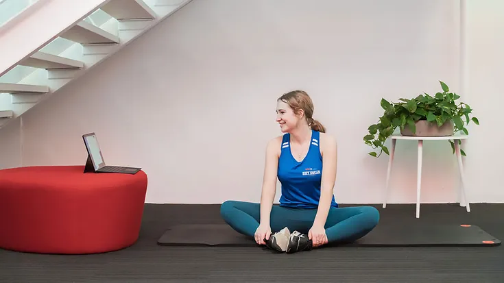 A woman doing a virtual workout at HighLow Fitness