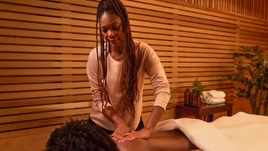 A client receiving a massage at a spa. 
