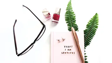 glasses and journal sitting on desk