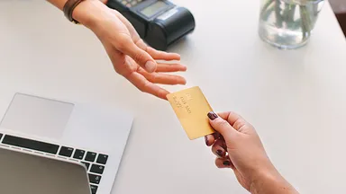 Person handing over credit card