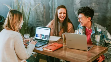 Group of happy people working at a table. 