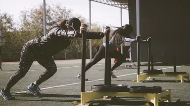 Women pushing weight sleds