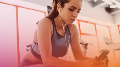 Person wearing headphones and using cell phone