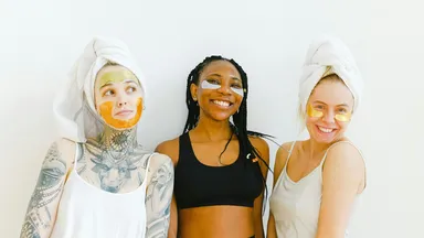 Three women smiling receiving spa treatments that they learned from WOM marketing