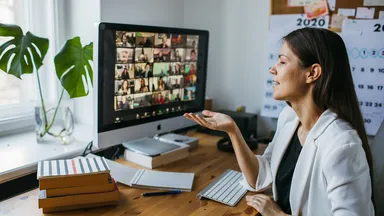 Woman in a blazer in front of a computer on a Zoom meeting