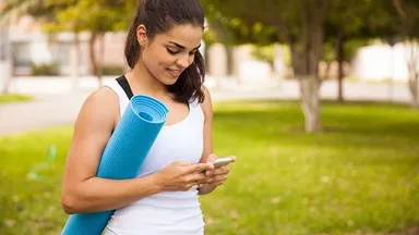 Woman on phone after yoga class