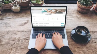 Woman using MINDBODY branded web tools