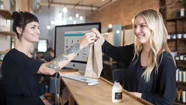 Woman checking out at salon front desk