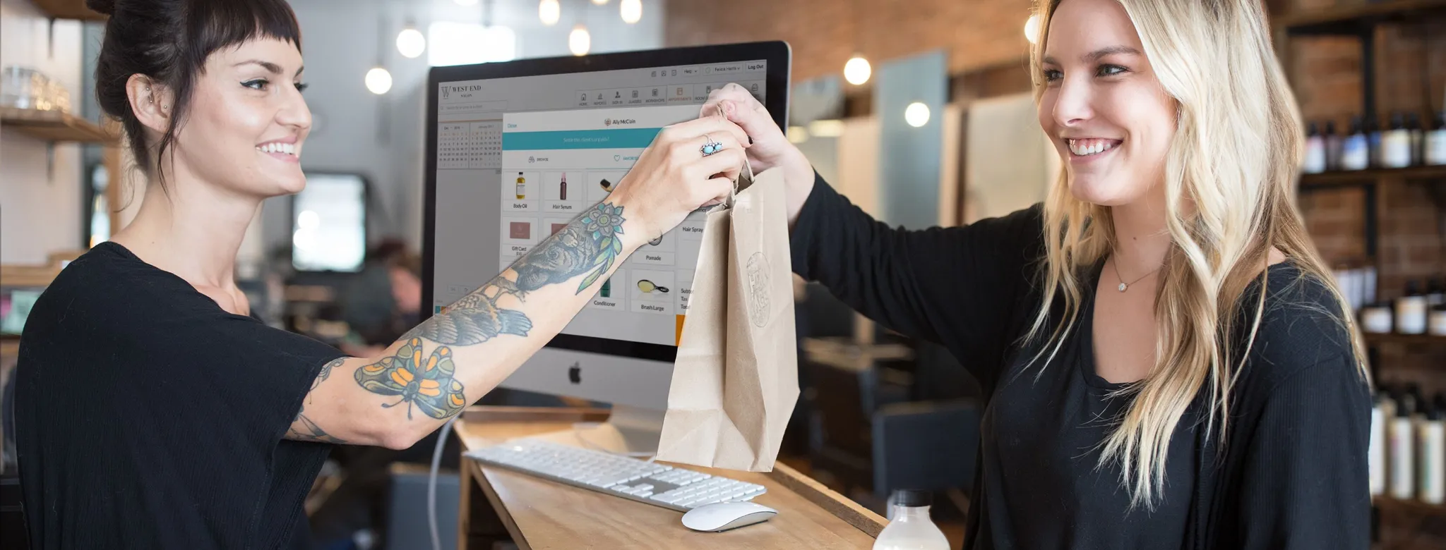 Woman checking out at salon front desk