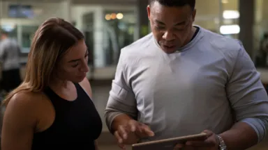 man and woman on ipad tablet