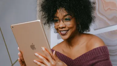 Woman smiling and working on an iPad