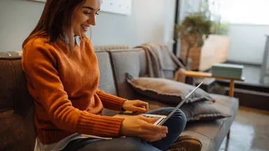 Woman working on laptop.