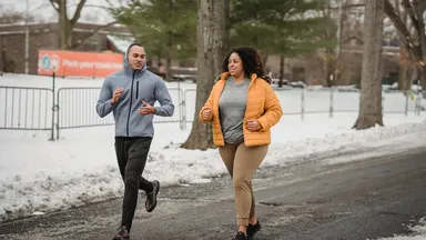 Two people working out outside.