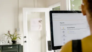 Woman pulling reports with her business management software