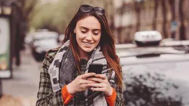 Woman looking at social media on her phone.